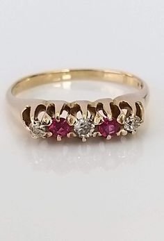 A beautiful early 20th century 18ct solid gold, ruby and diamond ring. The superb round shaped rubies are a lovely rich red colour, complemented by bright, well matched & sparkly old cut diamonds. The gallery and claws are in superb condition as is the entire piece. ▪ Overall Condition: Excellent ▪ Metal: 14ct Gold ▪ Gem: Diamond ▪ Gem: Ruby ▪ Gem Cut: Oval ▪ Gem Colour: Red ▪ Ring Size UK: M ▪ Ring Size US: 6.50 ▪ Resizing: Quotation Available ▪ Marked: 14k ▪ Weight: 2.70gms ▪ Insurance Estimate: £775 ▪ Payment Layaway Plan Available: Yes ▪ Full Detailed Appraisal: Quotation Available As a qualified Gemmologist and Jeweller with over 20 years experience in the jewellery  industry, each jewel is chosen for its  'quality, beauty and interest'... As a Consultant in a contemporary jewellery g Classic Red Ruby Ring With Single Cut Diamonds, Classic Red Diamond Ring With Single Cut Diamonds, Vintage Ruby Rings With Single Cut Diamonds, Classic Round Ruby Ring For Valentine's Day, Red Ruby Ring With Single Cut Diamonds For Wedding, Red Victorian Diamond Ring, Antique Red Diamond Ring With Gemstone, Antique Red Gemstone Diamond Ring, Antique Ruby Ring With Diamond Accents