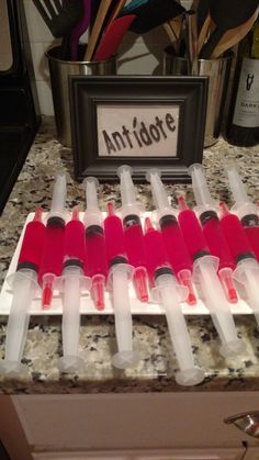 the bottles are lined up on the counter for test tubes to be filled with liquid