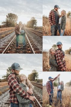 a man and woman standing next to each other on train tracks with their arms around each other