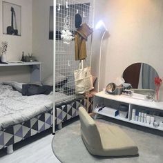 a room with a bed, mirror and shelves on the wall next to each other