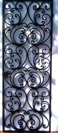 an iron gate with swirly designs on it's sides and the top part missing