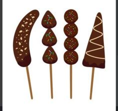 four chocolate lollipops on sticks with sprinkles in the shape of trees