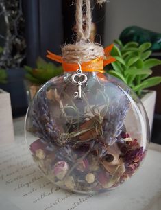 a glass ornament filled with dried flowers and herbs