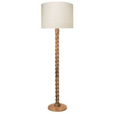 a lamp that is on top of a wooden base and has a white lampshade