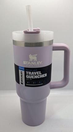 a travel mug with a straw sticking out of it