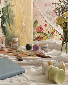 an artist's studio with flowers and paint