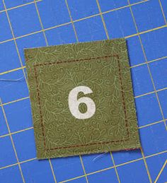 the number six is on top of a piece of fabric