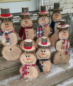 a group of snowmen made out of logs