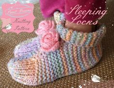 a doll's feet in knitted shoes with pink flowers on them and the words sleeping loons written below