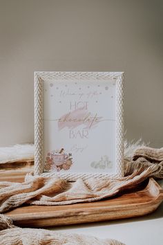 a wooden tray topped with a white frame filled with frosting and snowflakes