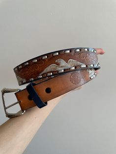 Vintage western genuine leather belt, wide (3,5 cm), brown, authentic, with engraved floral and eagle symbols, length - 39 cm, metal buckle, made in Mexico, perfect condition Western Brown Belt With Concho, Western Brown Belts And Suspenders With Antique Buckle, Western Style Brown Concho Belt, Western Brown Embroidered Belt, Western Style Brown Belt Buckle With Antique Buckle, Embroidered Brown Belt Buckle For Rodeo, Western Brown Antique Buckle Belt, Western Style Brown Antique Belt Buckle, Vintage Brown Embroidered Belt