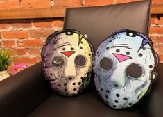 two pillows that have been painted to look like masks