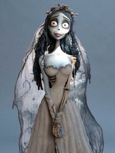 a corpse bride doll wearing a white dress