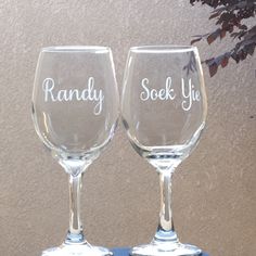 two wine glasses sitting on top of a table next to each other with the words randy and sock you written on them