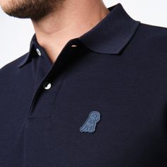 This men's classic piquŽ polo is a timeless must-have for any wardrobe. Crafted from the finest breathable Pima cotton, it features a sleek silhouette with an embroidered James Bark logo.Made in Peru100% Pima CottonEmbroidered James Bark LogoRibbed FinishesSide vents for added comfort Cotton Polo Shirt With Logo Patch, Casual Navy Polo Shirt With Embroidered Logo, Classic Navy Polo Shirt With Ribbed Collar, Navy Cotton Polo Shirt With Ribbed Collar, Classic Navy Fitted Polo Shirt, Classic Fitted Navy Polo Shirt, Classic Navy Cotton Polo Shirt, Casual Cotton Polo Shirt With Logo Patch, Polo Classic