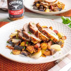 a white plate topped with meat and potatoes