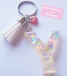 a keychain with a tassel hanging from it's side on a white surface