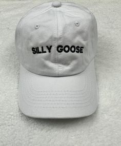 The words silly goose embroidered on a unstructured dad baseball hat.  Customize you hat with your choice of color. Primary Color is the hat color.  Item Details: 100% cotton twill Pigment dyed Garment washed Low Profile 6 panel Brass buckle or Velcro adjustable strap One size fits most No returns or exchanges on customized items. Please contact me at any time for concerns about your purchase. Funny Baseball Hats, Funny Baseball Hat, Goose Hat, Cool Dad Hats, Embroider Ideas, Silly Hats, Silly Shirt, Silly Goose, Funny Hats