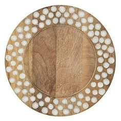 a wooden plate with white dots on it