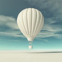 a white hot air balloon flying in the sky with clouds above it royalty illustration stock images