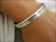 "This is a hand forged sterling silver cuff bracelet with a striped pattern. It's about 6.5mm width. Oxidized finish (blackened) to highlight the detail. -------------- How to measure? measure your wrist with a cord before the bone and then measure the cord with a ruler. Add 1/4\" to 1/2\" for a tight look or 3/4\" to 1\" for a loose look. Measures: S - bracelet measures 5\" plus 1\" gap = total 6\" M - bracelet measures 5.5\" plus 1\" gap = total 6.5\" L - bracelet measures 6\" plus 1\" gap = t Modern Silver Jewelry, Metal Cuff Bracelet, Sterling Silver Bangle Bracelets, Sterling Silver Cuff Bracelet, Sterling Silver Bangles, Silver Accessories, Sterling Silver Cuff, Silver Cuff Bracelet, Metal Bracelets