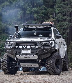 an off - road vehicle is parked in the woods