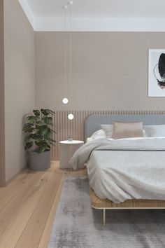 a bed sitting on top of a wooden floor in a bedroom