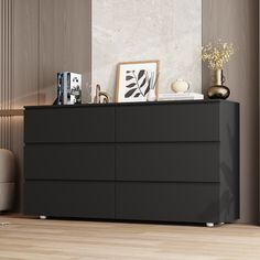 a black dresser sitting on top of a hard wood floor