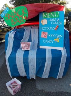 a blue and white striped chair with some food on it's back in the parking lot