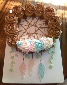 a cake decorated with icing roses and leaves