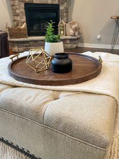 a living room with a couch, coffee table and fireplace in the backround