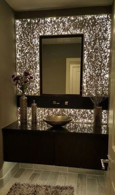 a bathroom vanity with lights on the wall