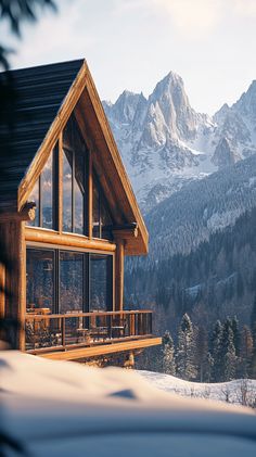 a cabin in the mountains with snow on the ground