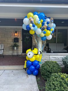 a bunch of balloons that are in the shape of a minion with glasses on them