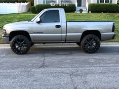 a silver truck parked in front of a house