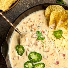 a bowl of quesadilla soup with tortilla chips on the side