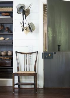 a wooden chair sitting in front of a doorway