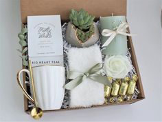 an open box with candles, flowers and other items