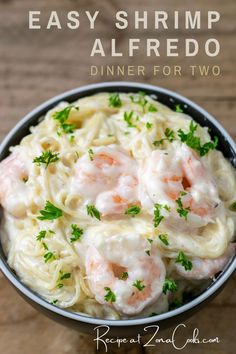 shrimp alfredo in a bowl with parsley on top