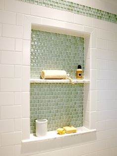 a bathroom with green tile and white walls