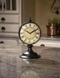 a clock sitting on top of a marble counter