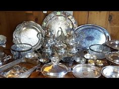 a table topped with lots of silver dishes