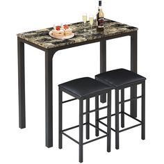 a table with two stools next to it and a bottle of wine on top