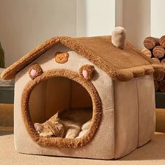 a cat is sleeping in a dog house