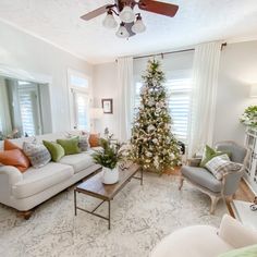 a living room filled with furniture and a christmas tree in the middle of the room