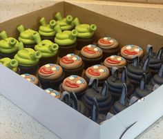 there are many cupcakes in the box with faces on them that look like monkeys