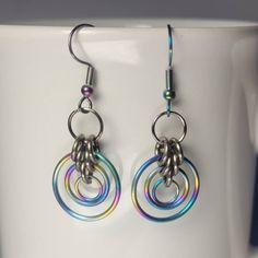 Handmade chainmail multicoloured rainbow earrings. Hand woven one ring at a time, this jewelry is sure to turn heads! This set is made of Rainbow  anodized titainium rings silver titanium rings and rainbow stainless steel hooks. These are ultra lightweight, do not tarnish and are comfortable to wear. I use high quality rings and the colours will not rub off on your skin. This product is made to order so it may take 10- 14 business days to ship Leo Jewelry, Rainbow Circle, Quality Rings, Rings Silver, Rainbow Earrings, Chain Mail, Titanium Rings, Hypoallergenic Earrings, One Ring