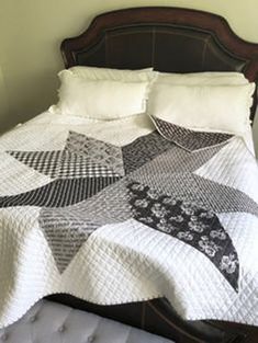 a bed with a quilt on top of it