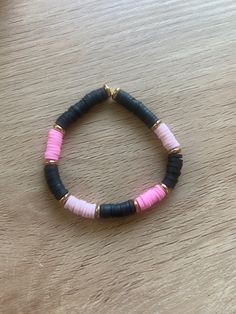 Allison pink is a pretty pink and black black bracket with a bit of gold that was named after one of my munchkins, Allison and just like her it's a fun and enjoyable bracelet that many people will like! This bracelet is also handmade and will fit teenagers and kids wrist comfortably. Black And Pink Clay Bead Bracelet, Black And Pink Bracelet, Cute Black Beaded Bracelets For Friendship, Trendy Black Handmade Stretch Bracelet, Trendy Handmade Black Stretch Bracelet, Cute Black Bracelet Jewelry, Cute Black Friendship Bracelets, Cute Adjustable Black Friendship Bracelets, Bracelet Perle Plate