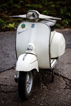 a white scooter is parked on the street